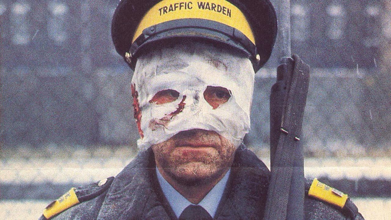 man in uniform with burns mask